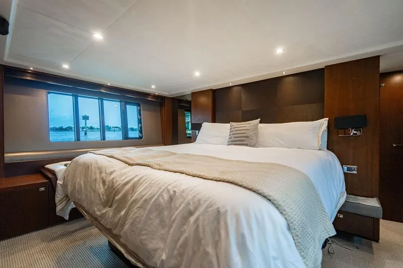  Yacht Photos Pics Luxurious bedroom interior of 2012 Princess Flybridge 72 Motor Yacht with large bed and window view.