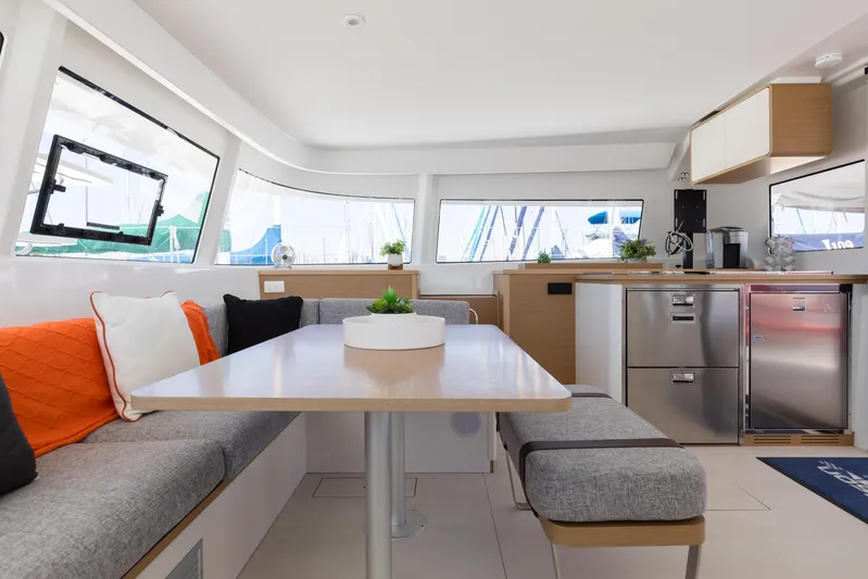In Stock Yacht Photos Pics Modern interior of 2024 Excess 14 yacht with sleek kitchen and cozy seating area.