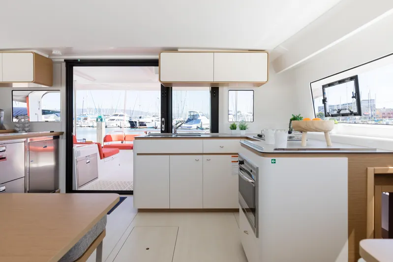 In Stock Yacht Photos Pics Modern kitchen interior of 2024 Excess 14 yacht with marina view.