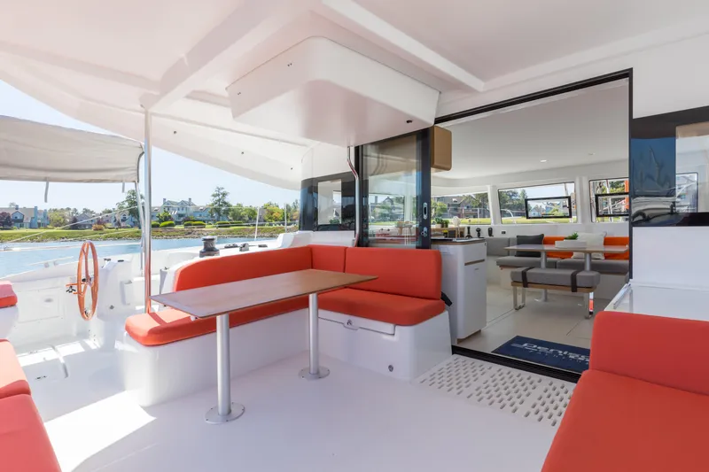 In Stock Yacht Photos Pics Luxurious 2024 Excess 14 catamaran interior with red seating and modern design.