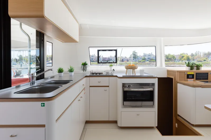 In Stock Yacht Photos Pics Modern kitchen interior of 2024 Excess 14 catamaran with sleek design and ample natural light.