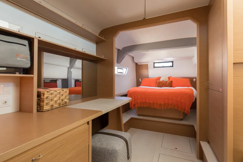 In Stock Yacht Photos Pics Luxurious cabin interior of 2024 Excess 14 yacht with cozy bed and modern decor.