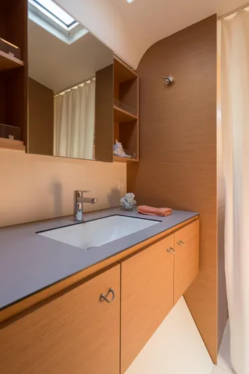 In Stock Yacht Photos Pics Modern bathroom in 2024 Excess 14 yacht with sleek wood cabinetry and mirror.