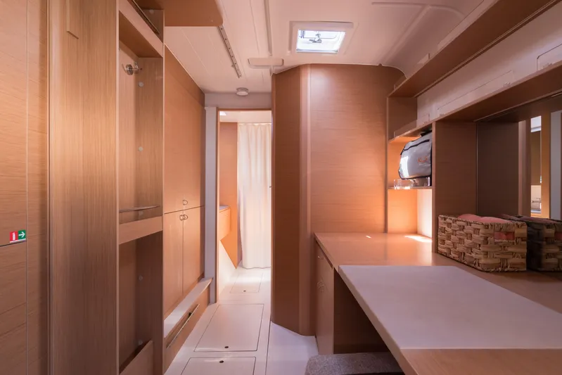 In Stock Yacht Photos Pics Interior of 2024 Excess 14 yacht, featuring modern wood finishes and ample storage space.