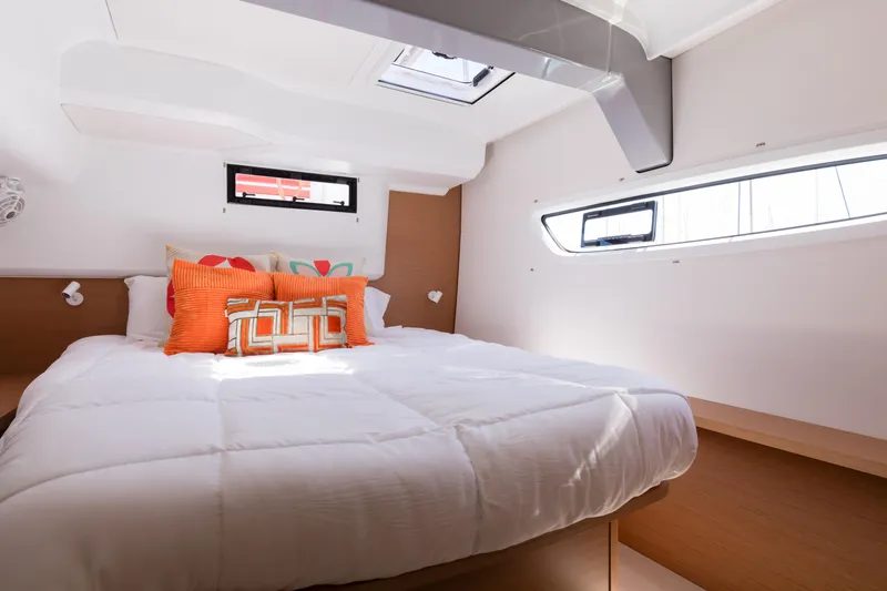 In Stock Yacht Photos Pics Luxurious cabin interior of 2024 Excess 14 yacht with modern bedding and natural light.