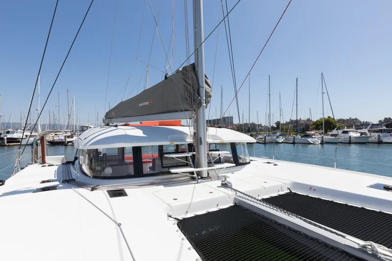 In Stock Yacht Photos Pics 2024 Excess 14 catamaran docked in a marina under clear blue skies.