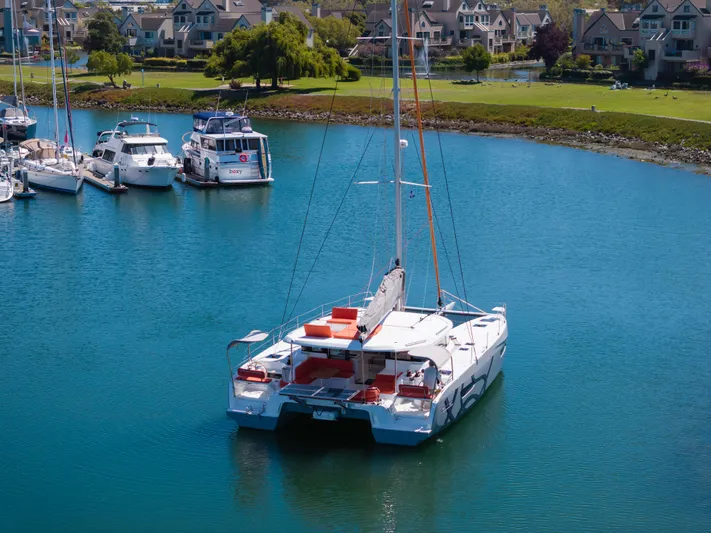 In Stock Yacht Photos Pics 2024 Excess 14 catamaran docked in a serene marina setting.