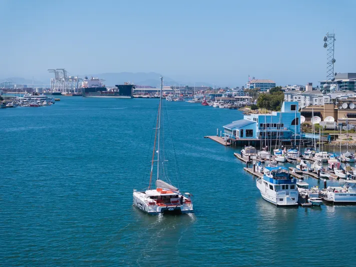 In Stock Yacht Photos Pics Catamaran Excess 14 sailing in a vibrant marina, 2024 model.