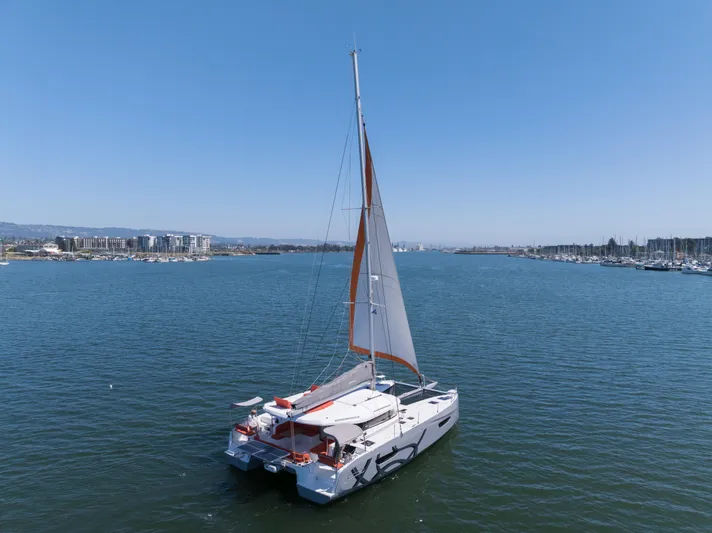 In Stock Yacht Photos Pics 2024 Excess 14 catamaran sailing on a calm blue sea.