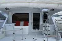 2004 Hatteras 70 Enclosed Bridge yacht deck with seating and ladder.