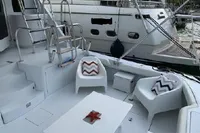 2004 Hatteras 70 Enclosed Bridge yacht deck with modern seating and table.