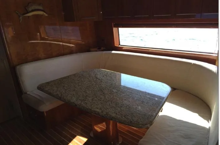  Yacht Photos Pics Luxurious dining area in 2004 Hatteras 70 Enclosed Bridge yacht with granite table.