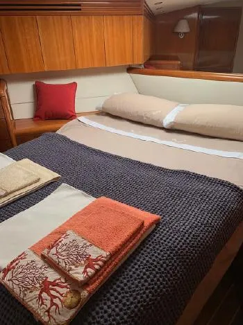  Yacht Photos Pics Luxurious bedroom interior of 2004 Hatteras 70 Enclosed Bridge yacht with cozy bedding.