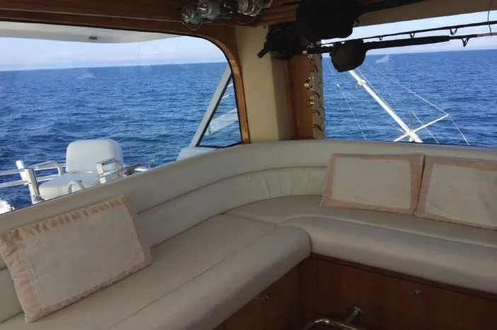  Yacht Photos Pics Interior view of 2004 Hatteras 70 Enclosed Bridge yacht with ocean backdrop.