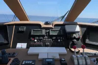 Control panel of a 2004 Hatteras 70 Enclosed Bridge yacht with ocean view.