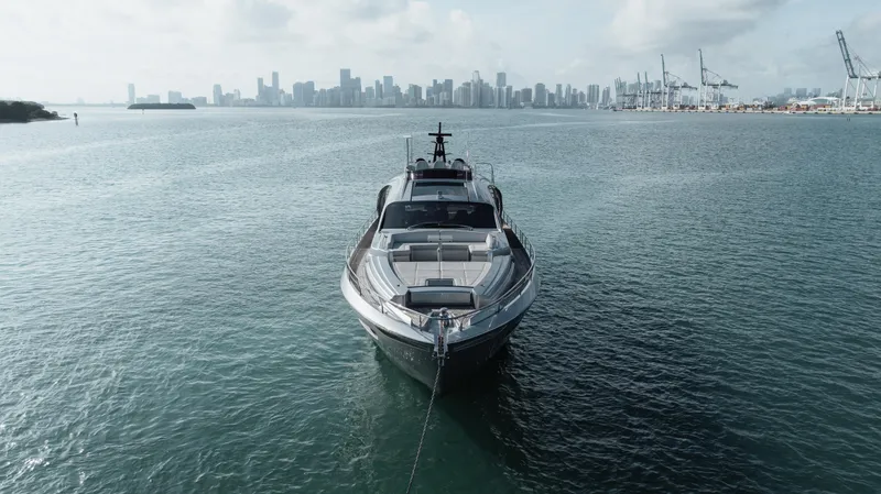 Alexandra Yacht Photos Pics Front view of 2020 Pershing 8X yacht on water with city skyline background.