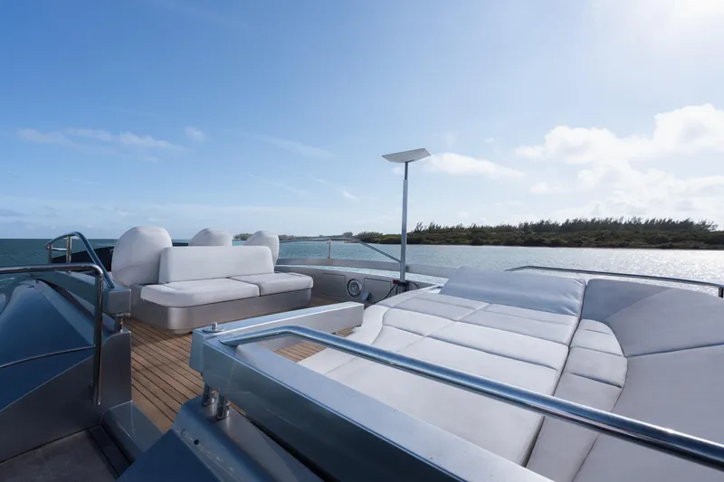 Alexandra Yacht Photos Pics Luxurious 2020 Pershing 8X yacht deck with plush seating, overlooking serene waters and clear skies.