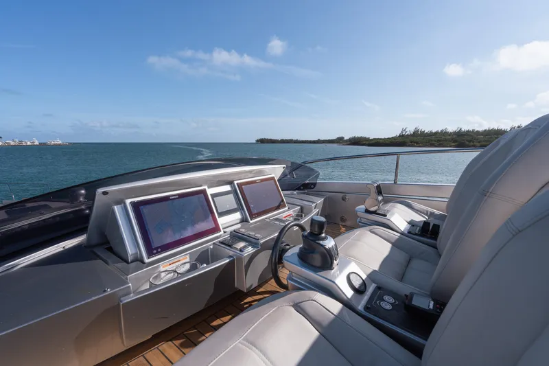 Alexandra Yacht Photos Pics Helm of 2020 Pershing 8X yacht with dual screens, steering wheel, and ocean view.