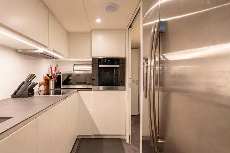 Alexandra Yacht Photos Pics Modern kitchen interior on 2020 Pershing 8X yacht with sleek appliances and cabinetry.