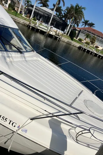 Sea Jeanie Yacht Photos Pics 1999 Viking Princess 52 Express Bridge yacht docked by waterfront homes.