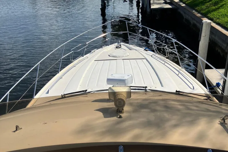 Sea Jeanie Yacht Photos Pics 1999 Viking Princess 52 Express Bridge yacht docked at marina, viewed from bow.