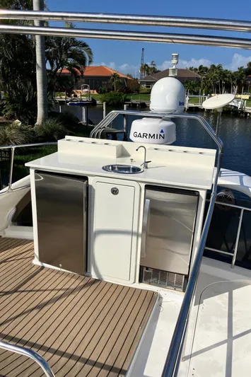 Sea Jeanie Yacht Photos Pics 1999 Viking Princess 52 Express Bridge yacht with outdoor kitchenette and Garmin equipment.