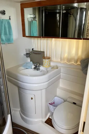 Sea Jeanie Yacht Photos Pics 1999 Viking Princess 52 Express Bridge yacht bathroom with sink, mirror, and toilet.