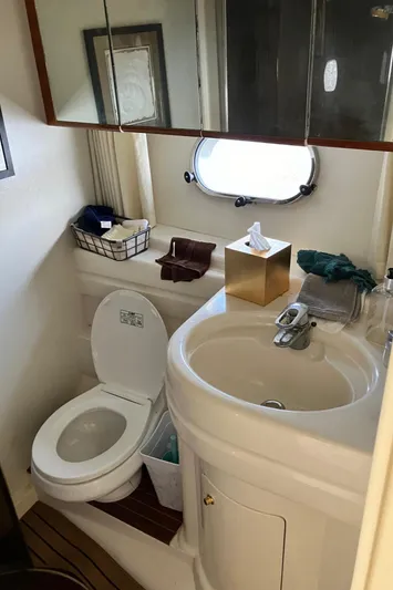 Sea Jeanie Yacht Photos Pics 1999 Viking Princess 52 Express Bridge bathroom with sink, toilet, and mirror.