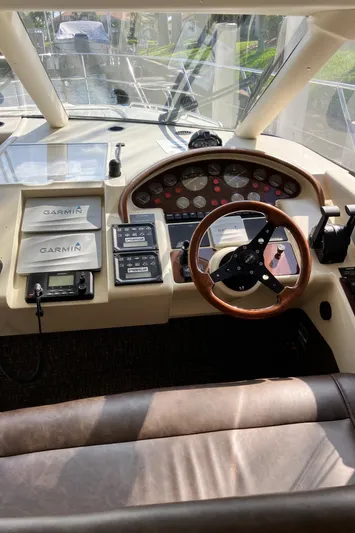 Sea Jeanie Yacht Photos Pics 1999 Viking Princess 52 Express Bridge helm with Garmin navigation and wood steering wheel.