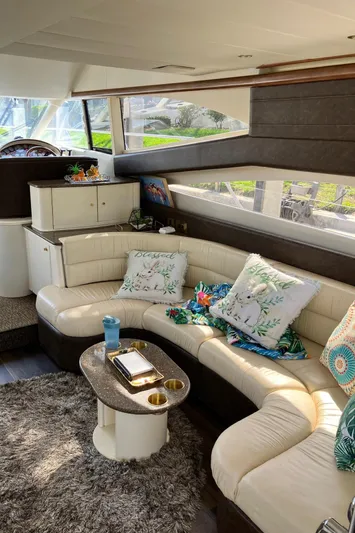 Sea Jeanie Yacht Photos Pics Luxurious interior of 1999 Viking Princess 52 Express Bridge yacht with plush seating and decor.