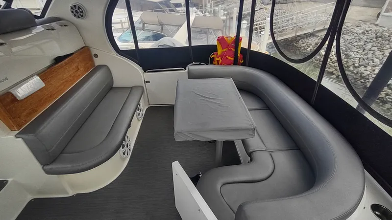  Yacht Photos Pics 2001 Cruisers Yachts 4450 Express Motoryacht interior with gray seating and table.