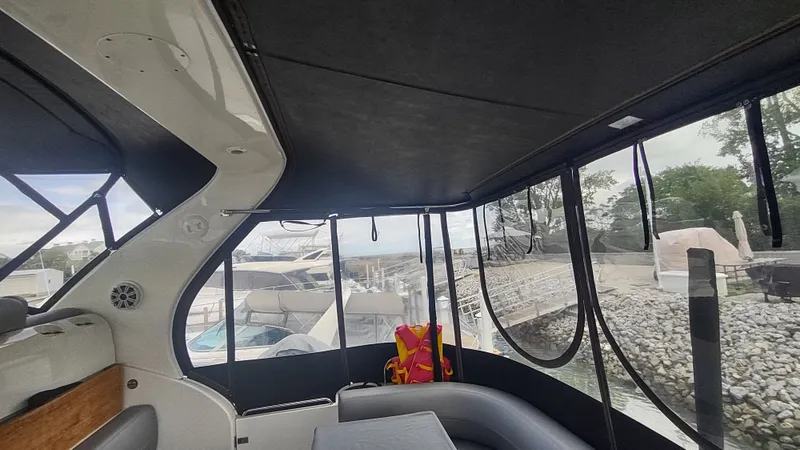  Yacht Photos Pics Interior view of 2001 Cruisers Yachts 4450 Express Motoryacht, featuring seating and dockside scenery.