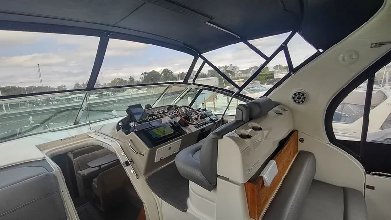  Yacht Photos Pics 2001 Cruisers Yachts 4450 Express Motoryacht cockpit with modern navigation equipment and comfortable seating.