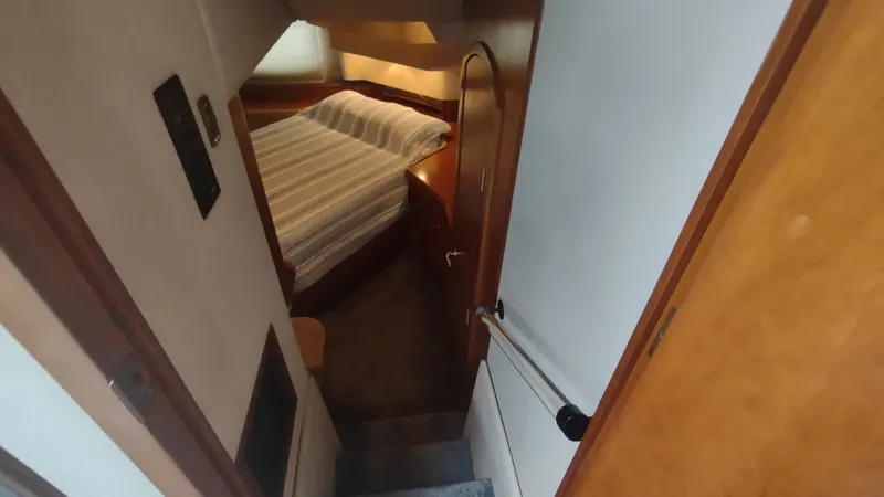  Yacht Photos Pics 2001 Cruisers Yachts 4450 Express Motoryacht interior cabin with bed and wooden accents.