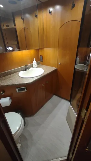  Yacht Photos Pics Luxurious bathroom in 2001 Cruisers Yachts 4450 Express Motoryacht with wood cabinetry and modern fixtures.