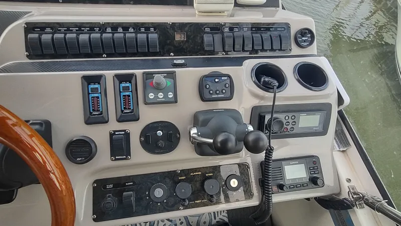  Yacht Photos Pics 2001 Cruisers Yachts 4450 Express Motoryacht helm with controls and navigation equipment.