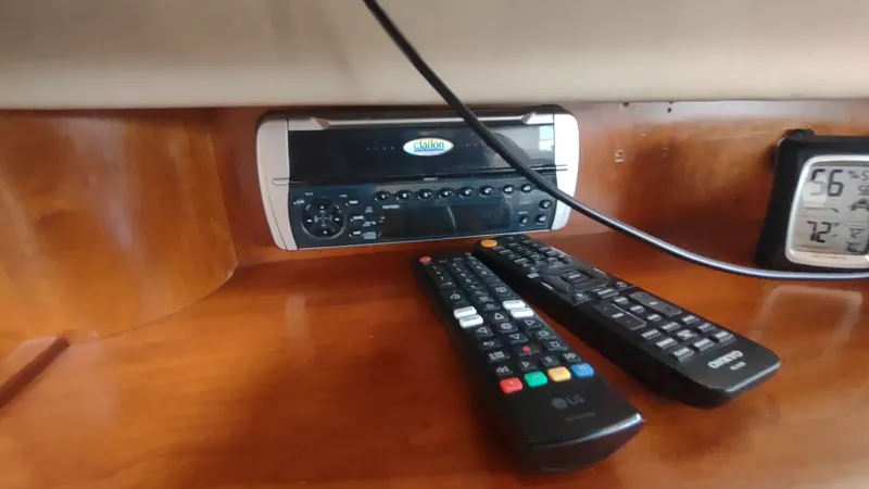  Yacht Photos Pics 2001 Cruisers Yachts 4450 Express Motoryacht interior with stereo, remotes, and digital thermometer.