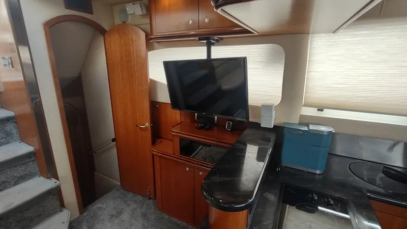  Yacht Photos Pics Interior of 2001 Cruisers Yachts 4450 Express Motoryacht with TV and kitchenette.