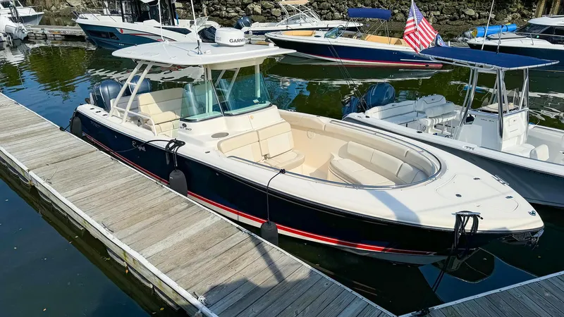 4784mm Yacht Photos Pics 2014 Pursuit ST 310 Sport boat docked in marina, featuring sleek design and spacious seating.