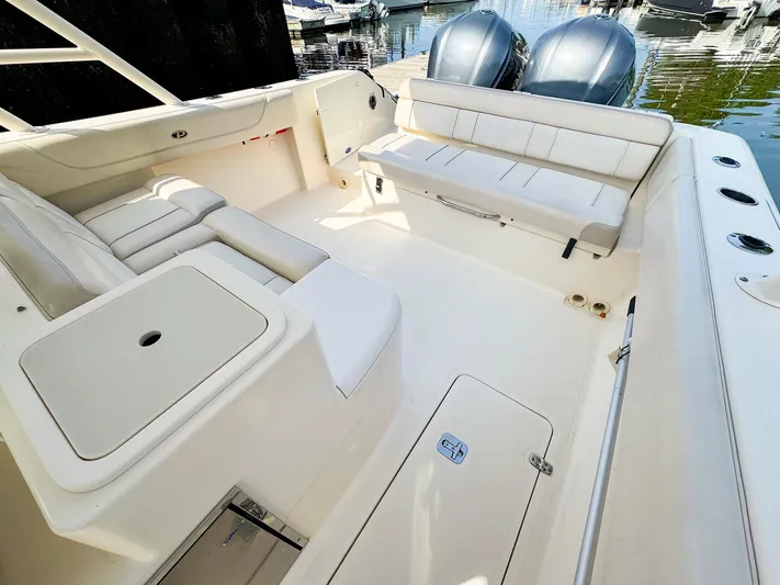 4784mm Yacht Photos Pics 2014 Pursuit ST 310 Sport boat interior with seating and storage compartments.