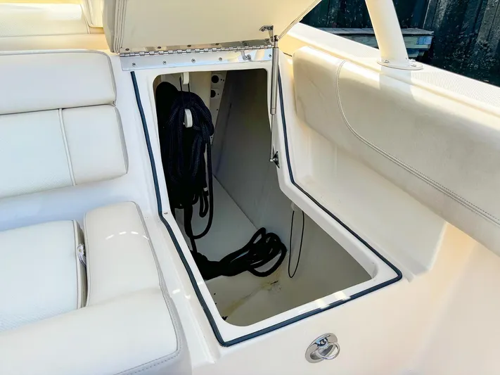 4784mm Yacht Photos Pics Open storage compartment on 2014 Pursuit ST 310 Sport boat with coiled rope inside.