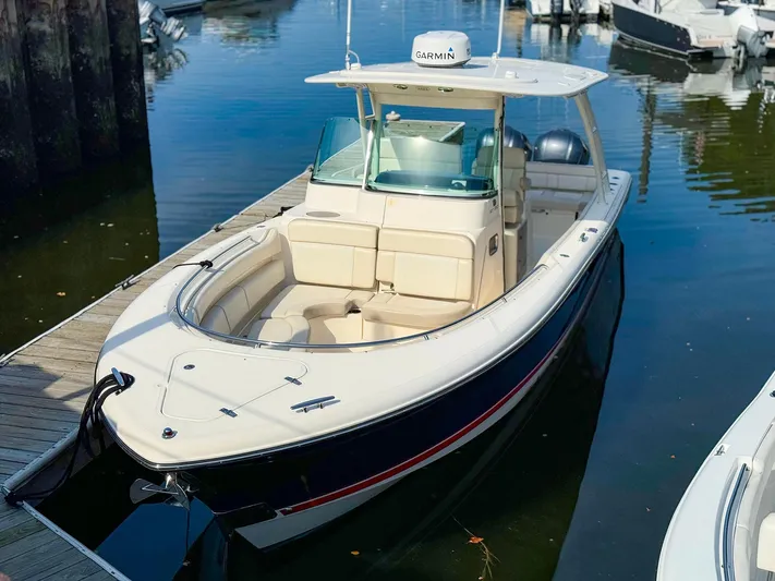 4784mm Yacht Photos Pics 2014 Pursuit ST 310 Sport boat docked in marina, featuring sleek design and Garmin equipment.