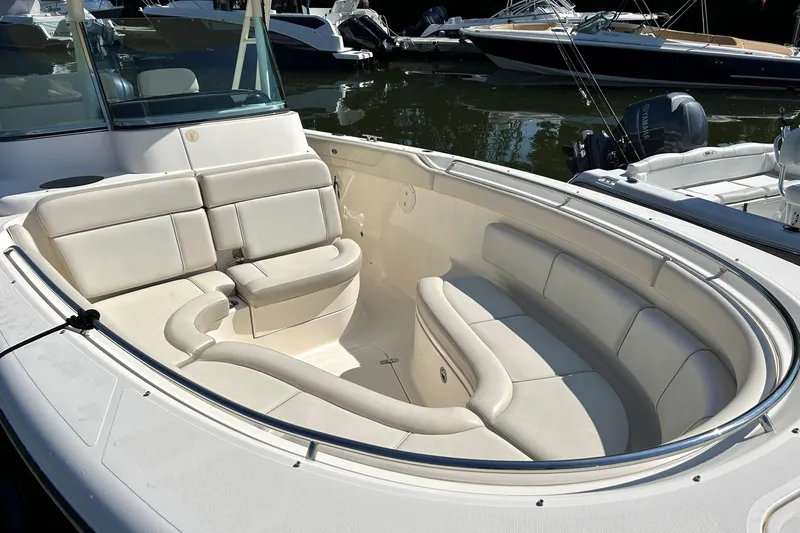 Esprit Yacht Photos Pics 2014 Pursuit ST 310 Sport boat with spacious seating, docked on calm water.