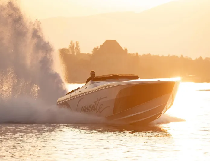  Yacht Photos Pics 2016 Cigarette 50' Marauder speedboat cruising at sunset, creating a dramatic water splash.