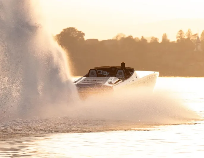  Yacht Photos Pics 2016 Cigarette 50' Marauder speedboat creating splash at sunset on water.