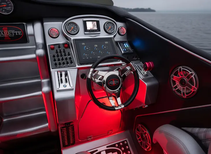  Yacht Photos Pics Cockpit of 2016 Cigarette 50' Marauder boat with illuminated controls and steering wheel.