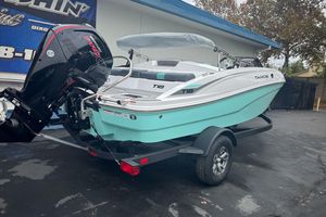 2026 Tahoe T18 boat on trailer with Mercury engine, parked outdoors.