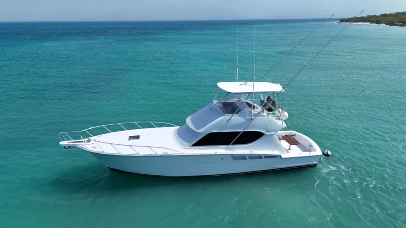  Yacht Photos Pics 2005 Hatteras 50 Convertible yacht on clear turquoise water.