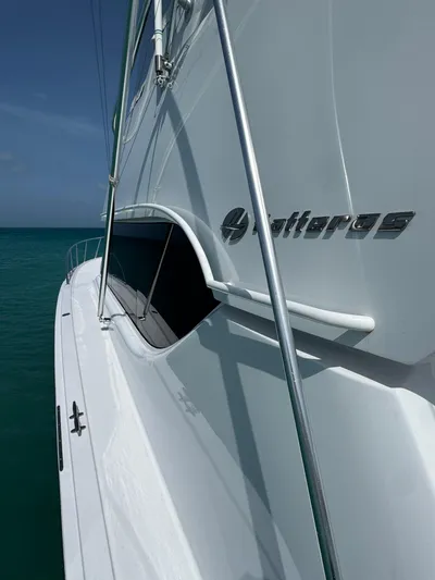  Yacht Photos Pics 2005 Hatteras 50 Convertible yacht side view on calm ocean waters.