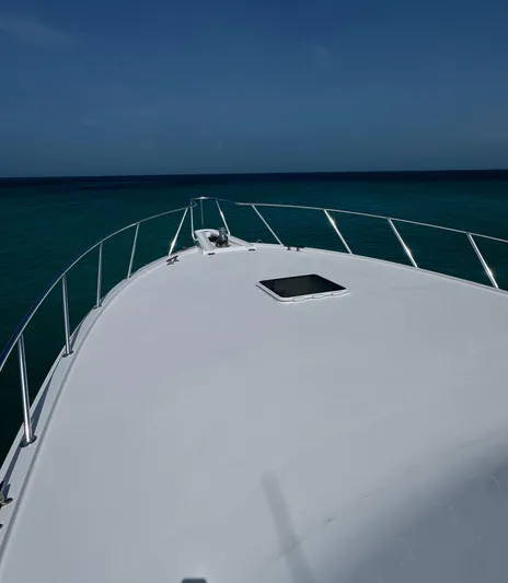  Yacht Photos Pics Bow view of 2005 Hatteras 50 Convertible yacht on open sea.